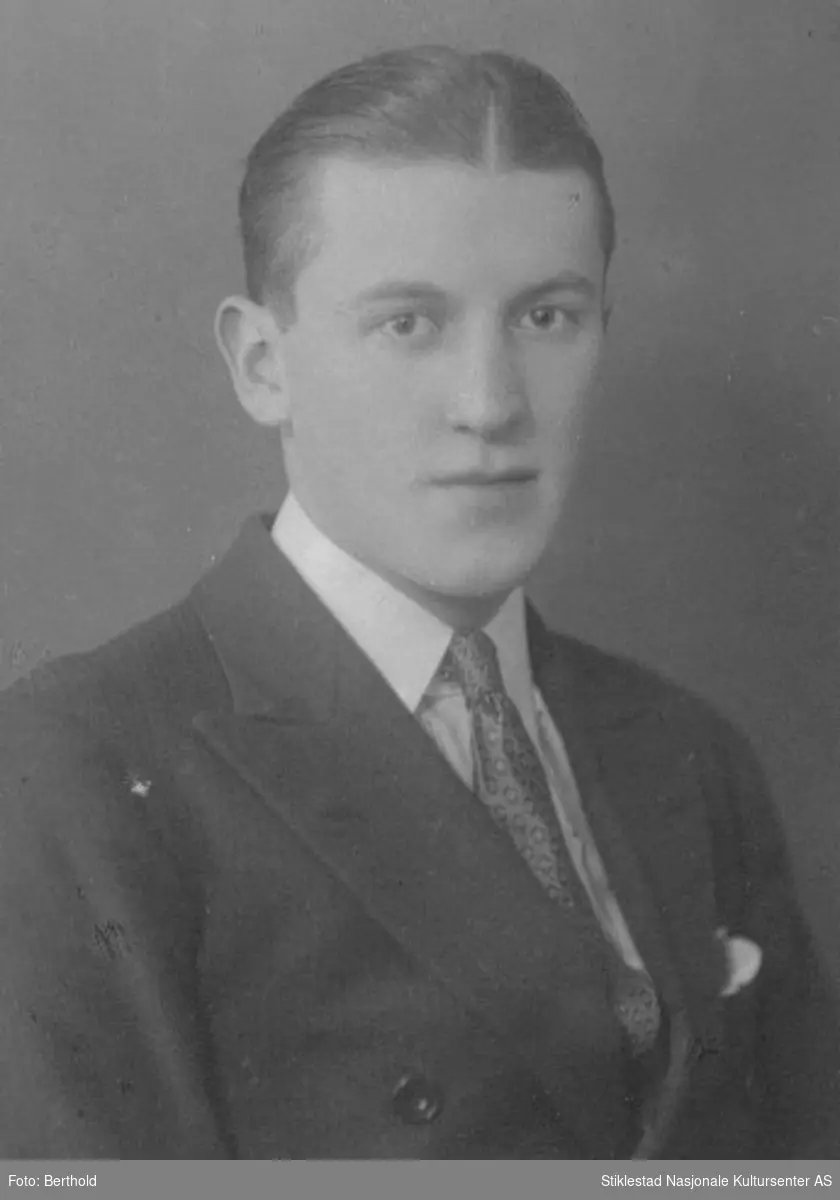 Portrett av Cyril Emanuel Moe som ung mann i mørk dress, hvit skjorte og slips