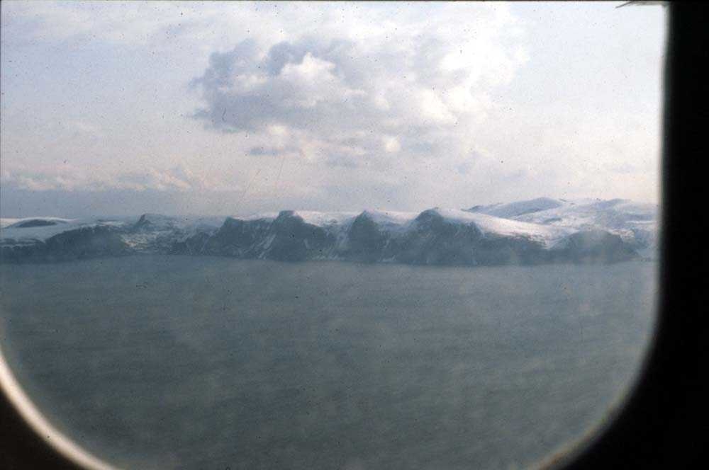 Luftfoto. Fjellrekke langs fjorden dekket av sne. Ett sted i nord.
Foto tatt fra DHC-6-300 Twin Otter fra Widerøe.
