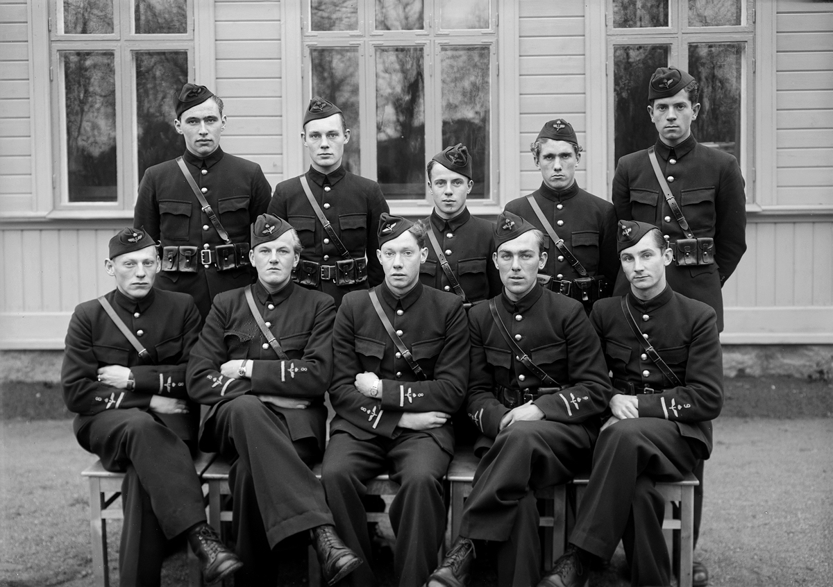 Elever vid korpralskolan på F 3 Östgöta flygflottilj, 1942. Tio stycken elever, från F 8 och F 9. Grupporträtt framför byggnad.