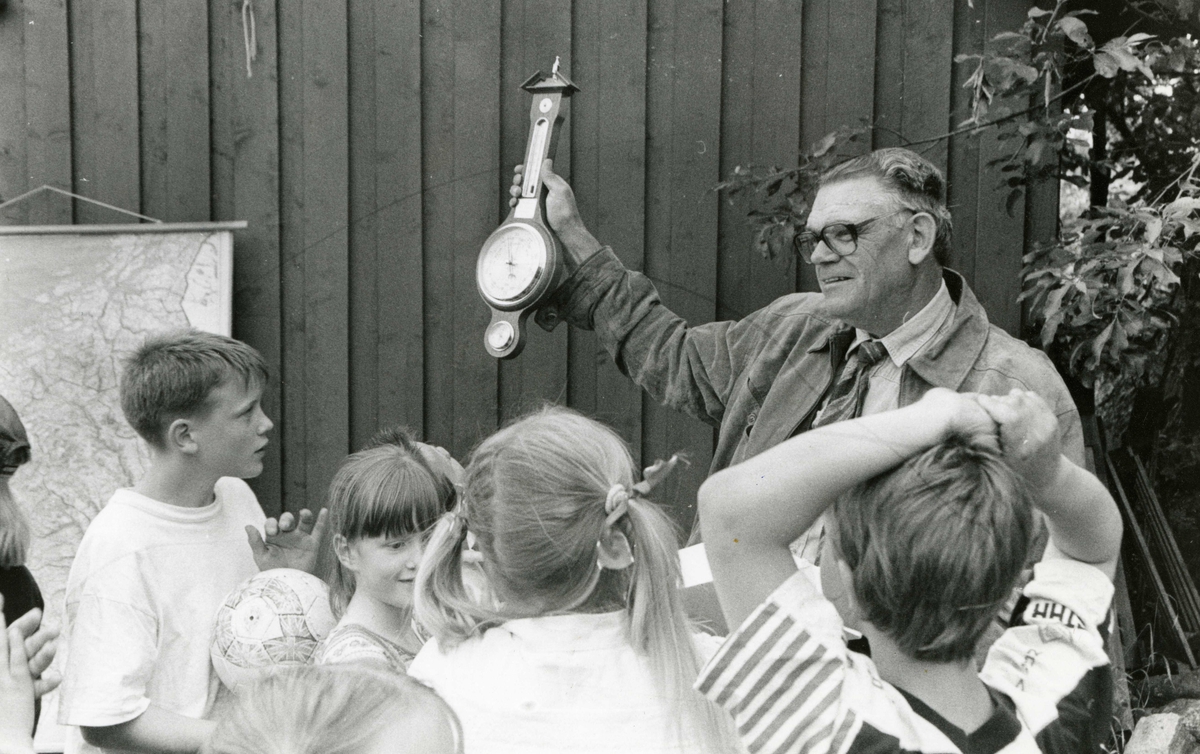 Lærer Anton Klausen holder opp et barometer for elever ved Kjølebrønd skole.