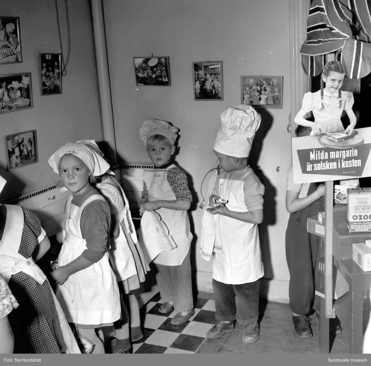 Vita Bandets Kindergarten (lekskola) med glada barn som stökar i köket.