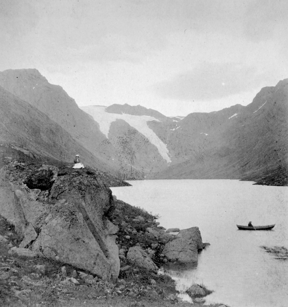 "Snebre - Bergsfjord. Finnmark." Til venstre sitter en kvinne på toppen av en klippe. Til høyre sitter det en person i en robåt.