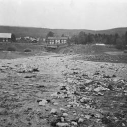 Utsikt mot Knipstugu etter flommen i 1938, tre bygninger len
