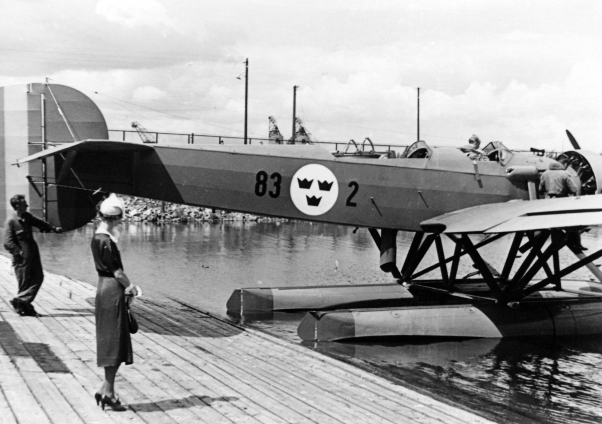 Flygplan S 5 Heinkel He Hansa märkt nummer 83 från F 2 Roslagens flygflottilj står på vatten vid en brygga. 1930-tal.