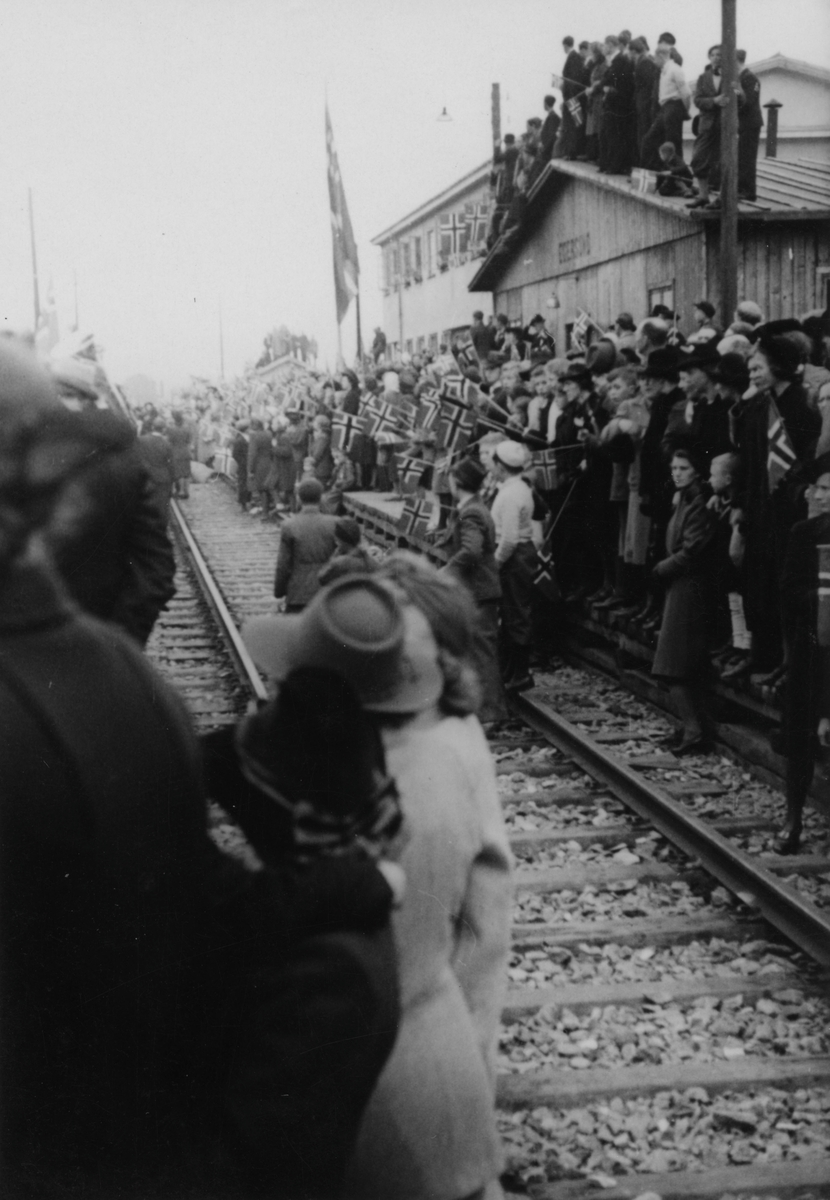 Folk venter på toget med grinifangene, 10. mai 1945.