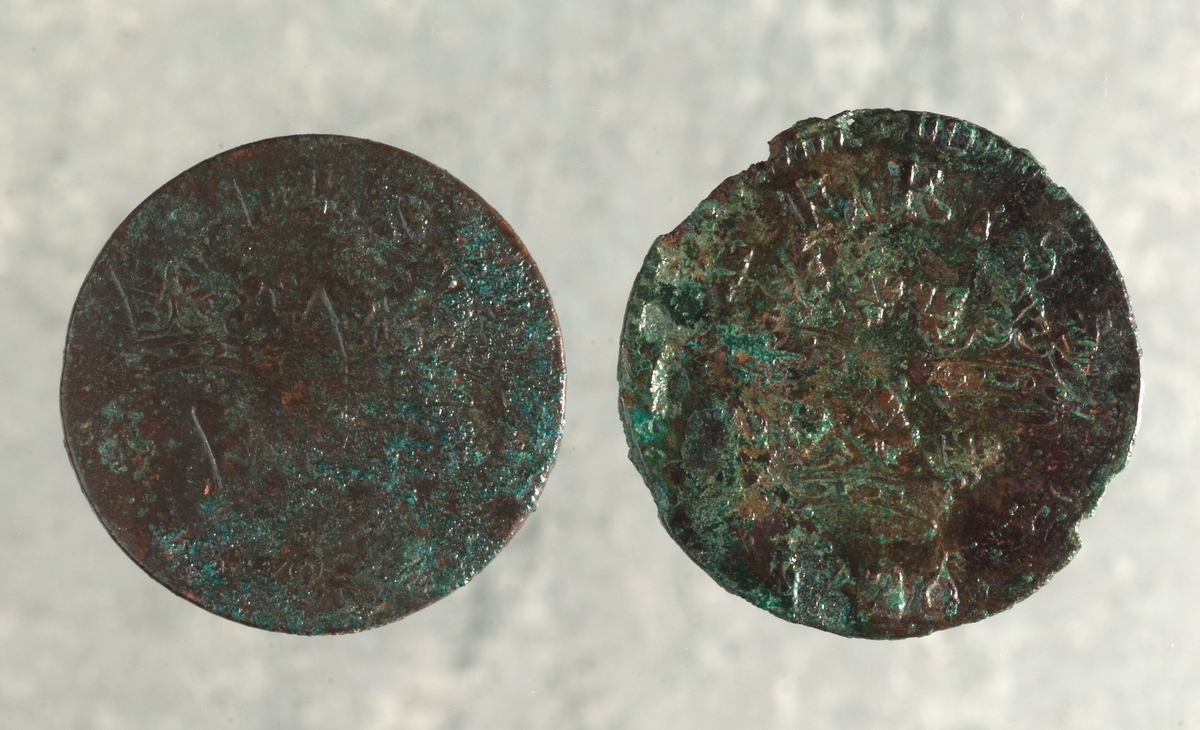 Mynt av kopparlegering. 1 öre KM. Fredrik I (1720-1751). Präglat 1720 i Stockholm. Myntet till höger på bilden.