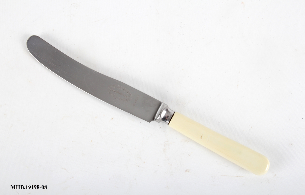 Kniv med plastskaft og rett knivblad med avrundet avslutning.