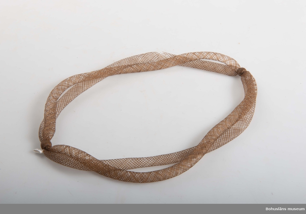 Halsband tillverkat av människohåri dubbla rader, (länkar).
Se även UM018732.