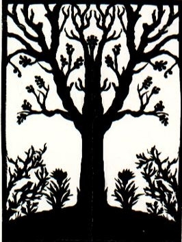 Motivet är klippt ur svart papper och föreställer ett träd med buskar och blommor under.