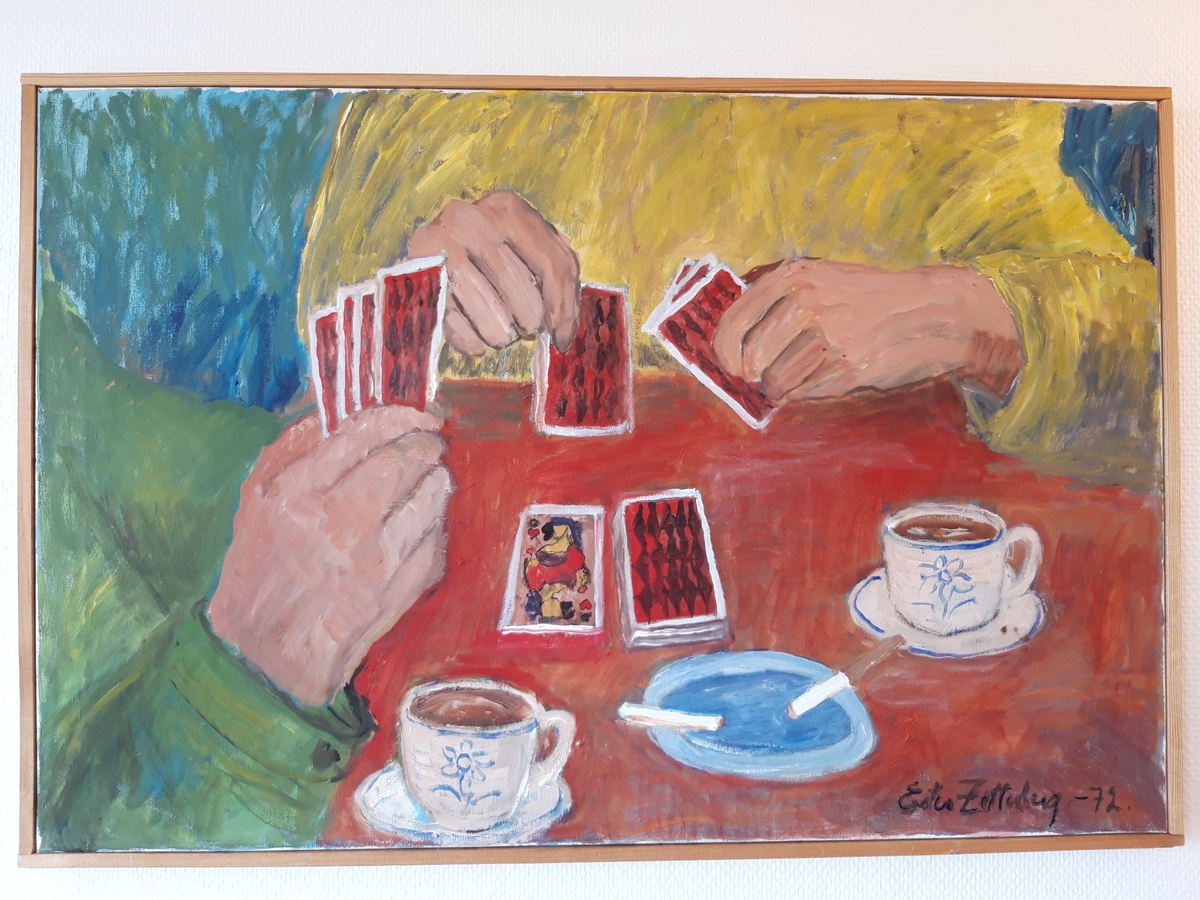 Bilden upplevs "beskuren" så att endast ett bord och två kortspelares händer syns. På bordet står också två kaffekoppar och en askkopp.
