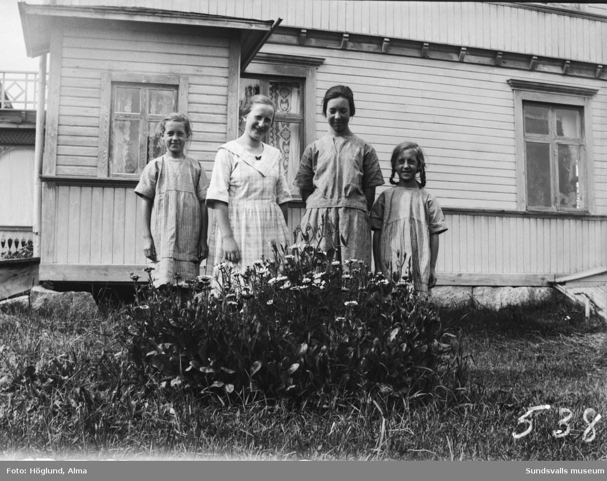 Systrarna Hilma, Ingrid och Irma Höglund, samt Göta Bäckström ståendes framför Götas hem i Fanbyn.