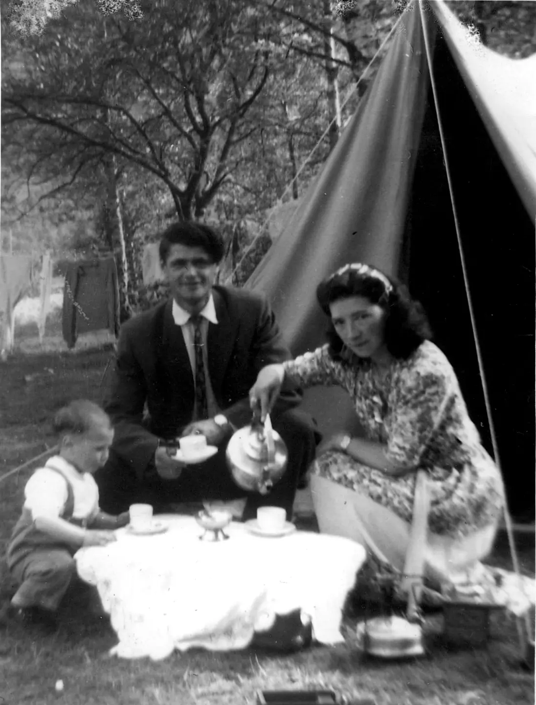 Oliver Alexander and Karoline Oliversen with their son in Ørstad at Sunnmøre. Karoline is serving coffee, ca 1950.