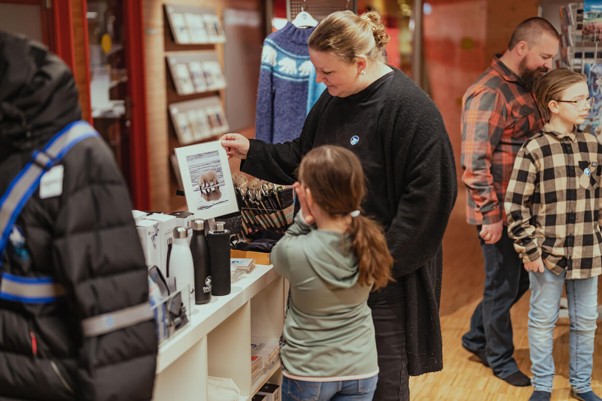 The photo shows a woman and a girl in the museum gift shop.