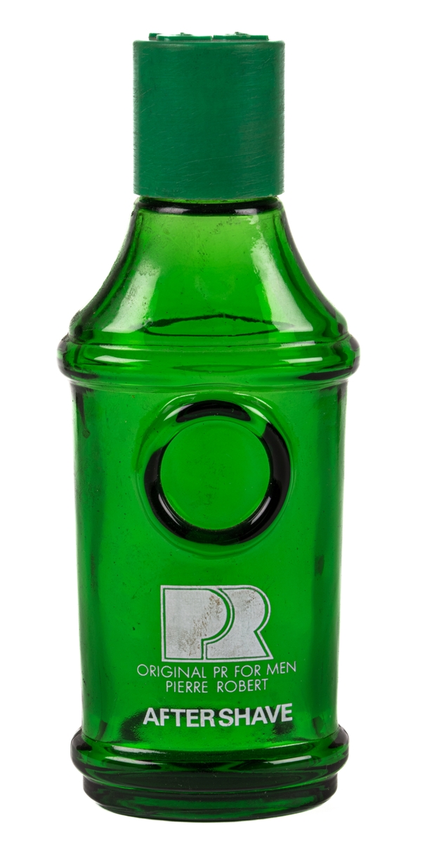 Flaska av grönt glas med skruvlock i grön plast. Flaskan är ovalt rundad med bredare fram och baksida. Längst ned och vid ca 2/3 höjd av flaskan finns en utstående rundad list i glaset runt hela flaskan. Över den övre listen avsmalnar flaskan uppåt. Flaskan avsmalnar något nedåt mellan listerna. PÅ framsidan under den övre listen finns en utbuktning. Under den står i vitt tryck "PR ORIGINAL PR FOR MEN PIERRE ROBERT AFTER SHAVE". Fabrikationstryck i glaset i botten med en otydlig text där endast ordet "SWEDEN" går att urskilja. På locket i stora utstående bokstäver står "PR".