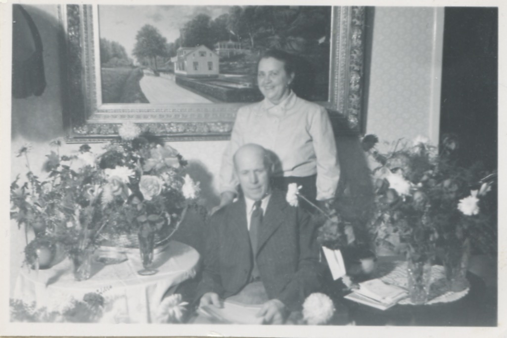 Axel Johansson (1895 - 1974) fyller 60 år och uppvaktas med blommor, Labacka Lund 1955. Snett bakom honom står hustrun Lisa (1898 - 1977).