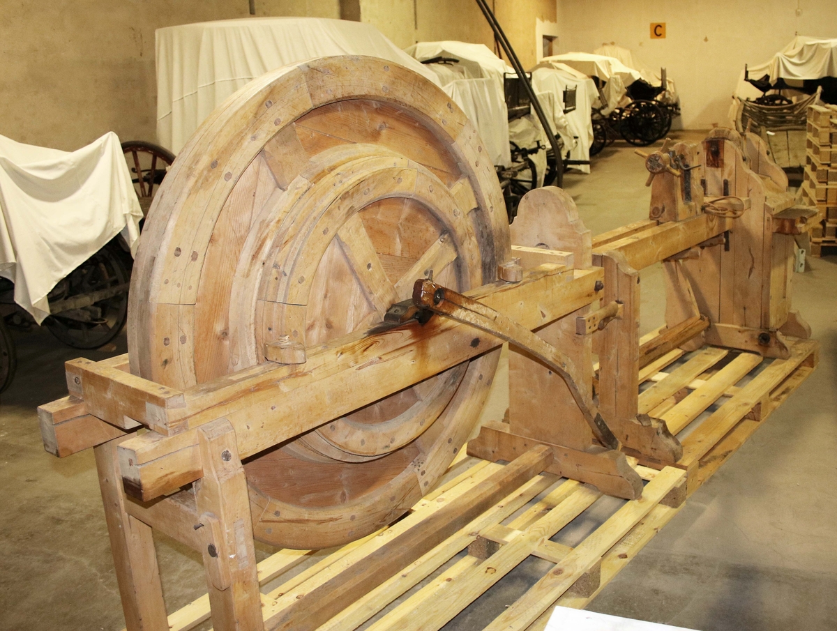 Svarv av 2 delar i ofärgat trä. En del, med stort vertikalt stående svänghjul. En del, med fästen för stycket som skall svarvas. På sidan, 3 lådor för svarvjärn, mallar och andra verktyg. Rem av snott läder. Svarven ställdes i vinkel vid användning. 

Svarven tillverkades av Anders Johan Lundgren (1859-1930), på Lida Övre, Överlida. Anders var snickare och tillverkade sparkstöttar, stolsben m.m.