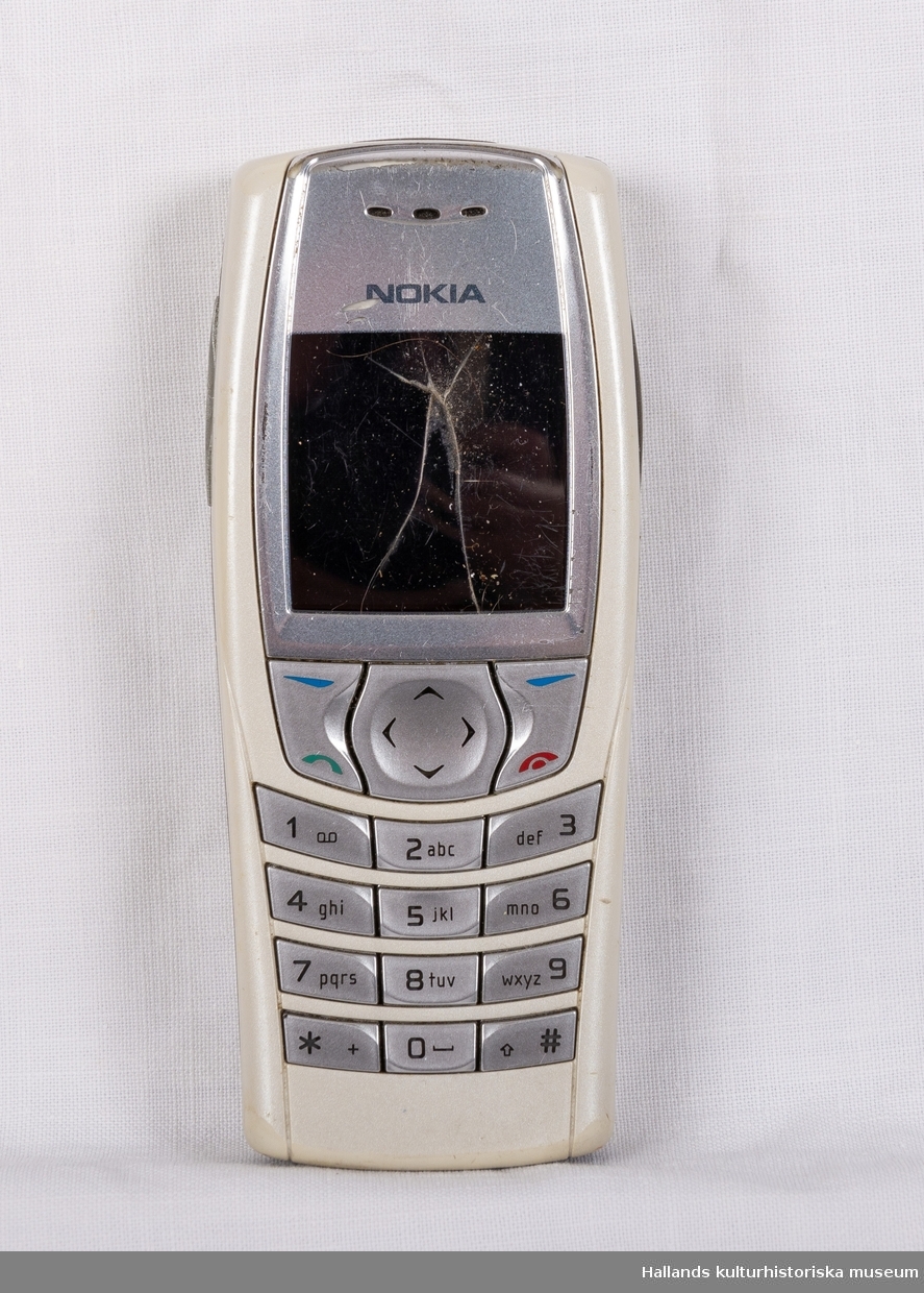 Nokia 6610 (Tillverkare: Nokia, modell: 6610) med yttre skal av grå hårdplast. På dess framsida en digital skärn, knappsats i silverfärgad hårdplast, samt tillverkarens logotyp "Nokia" ovanför skärmen. Telefonens baksida (även den märkt med företagets logotyp) är avtagbar för åtkomst till batteri och telefonkort (simkort). I telefonen sitter ett telefonkort från teleoperatören Telia. På telefonens undersida en kontakt under lucka.

Skärmen har en krosskada.