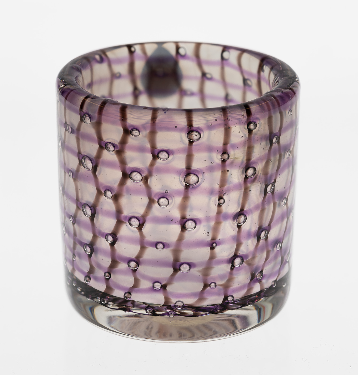 Sylindrisk vase i polykromt gjennomskinnelig glass. Tykke vegger i klart glass, dekorert med lilla horisontale og brun vertikale striper samt luftbobler.