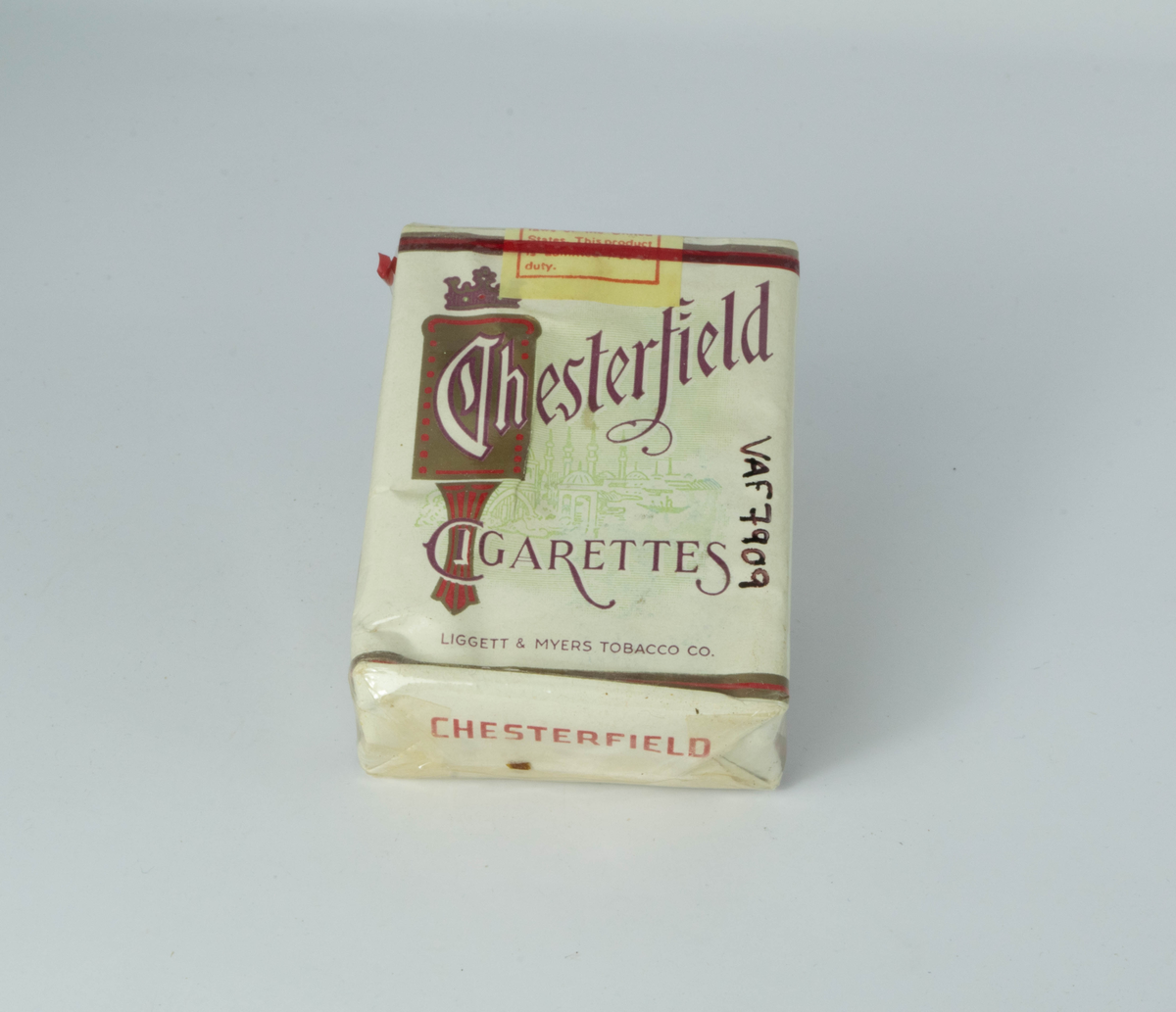 Rektangulær pakke. 20 sigaretter inni sølvpapir, deretter papiromslag og ytterst cellofan med rød åpnesnor rundt ene ende.