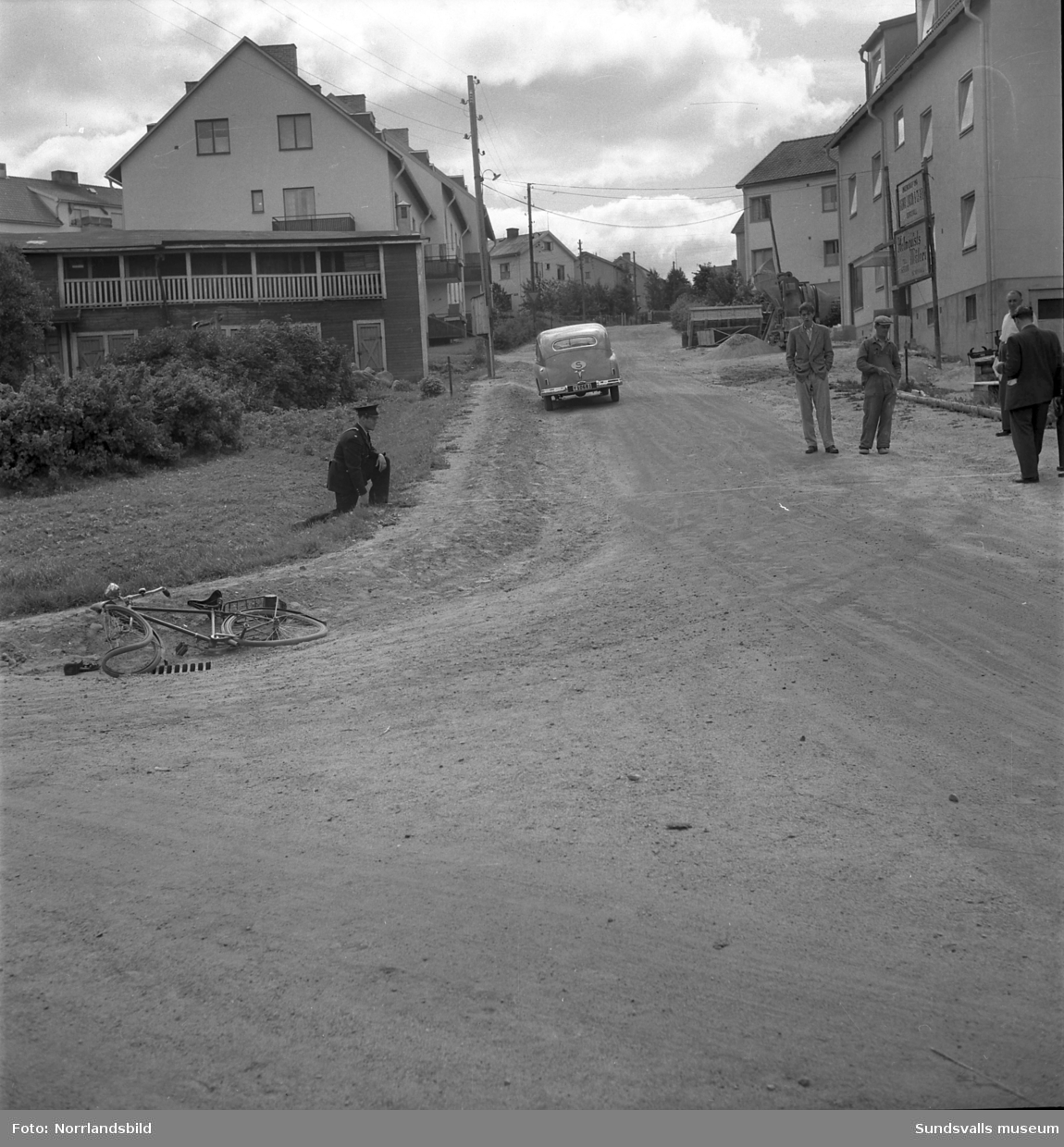 Polis på plats vid Skogsgatan på Östermalm efter en cykelolycka 1949. Det mesta av bebyggelsen är densamma som nu (2015).