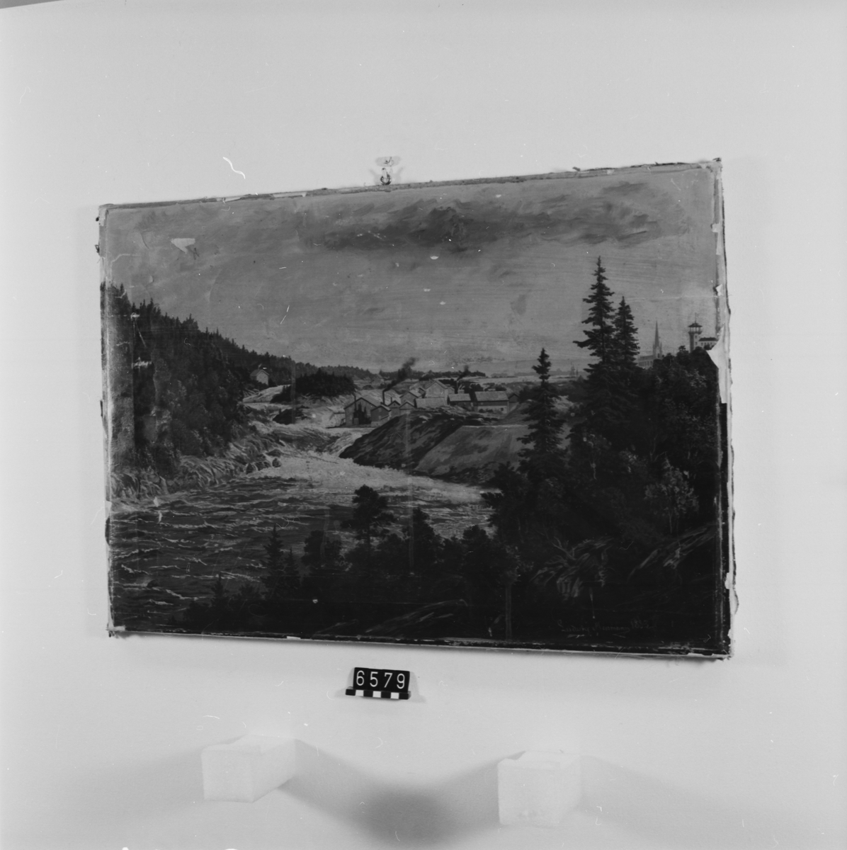 Oljetryck efter tavla, signerad Neumann 1883. Totalvy över Trollhättefallen. Delvis övermålat i olja, särskilt himlen. Uppklistrat på en duk på spännram.