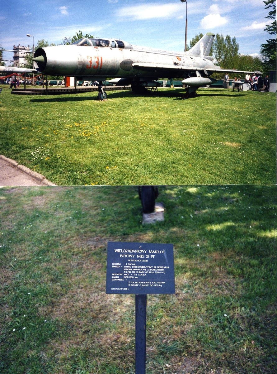 Landskap. Et fly, MiG-21PF, står parkert. Dette er ett av objektene som står oppstilt på et utstillingsområde for flyinteresserte besøkende.