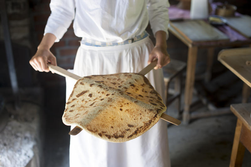 Woman showing a traditional baked lefse