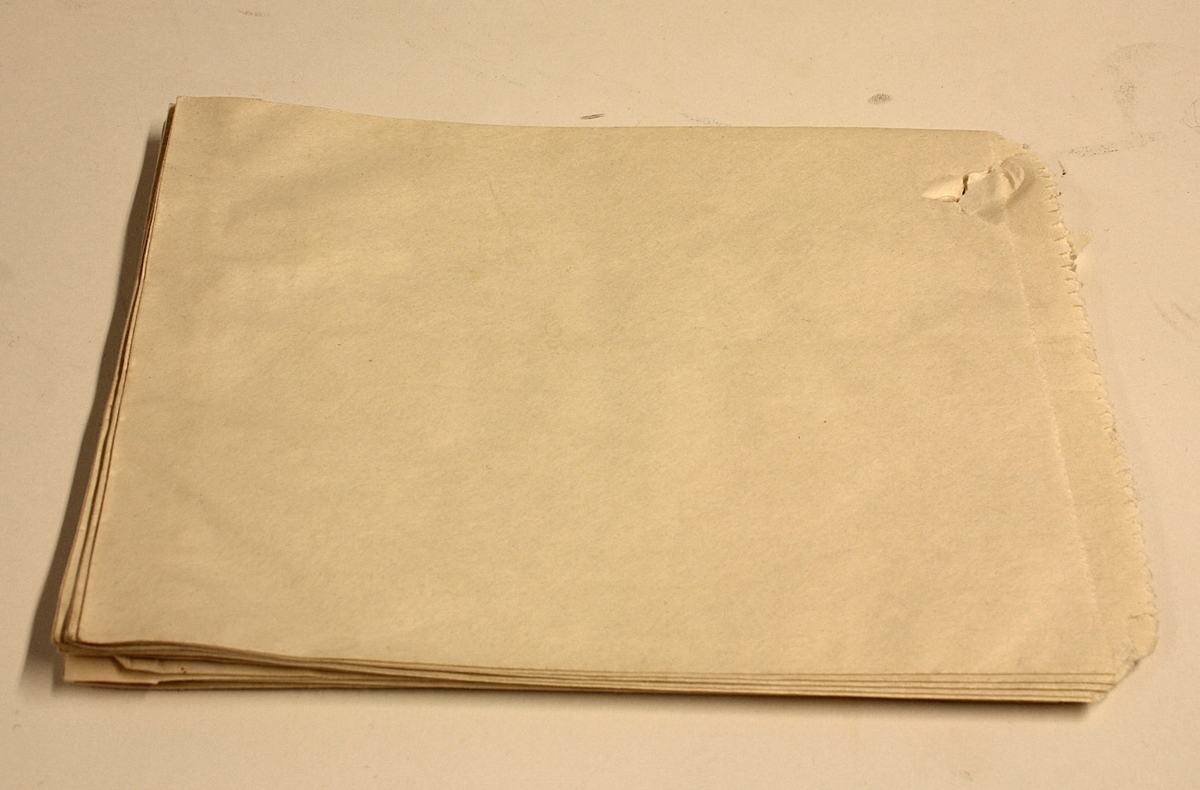13 stykk rektangulære poser i glatt, brunt papir. Gjerne brukt i forbindelse med salg av søtsaker ol.