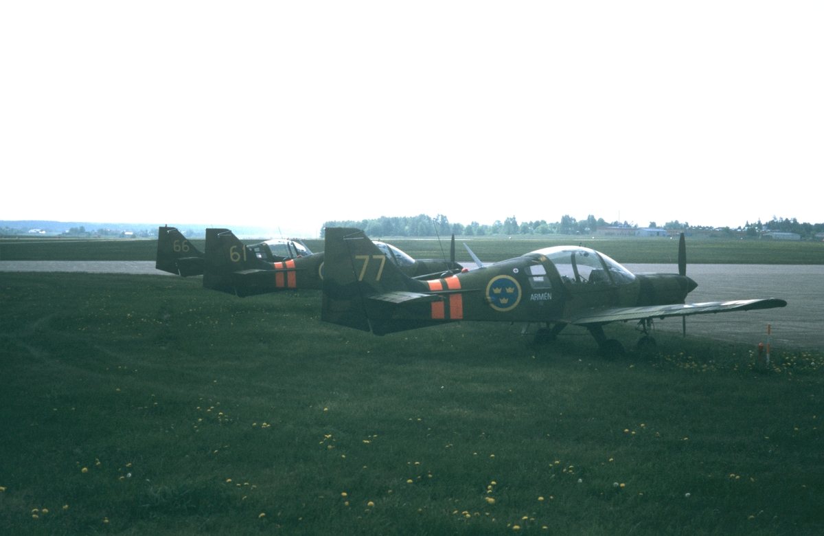 Tre flygplan SK 61 nummer 66, 61 och 77 tillhörande Östgöta Arméflygbataljon står på flygfältet på Malmen, våren 1981.