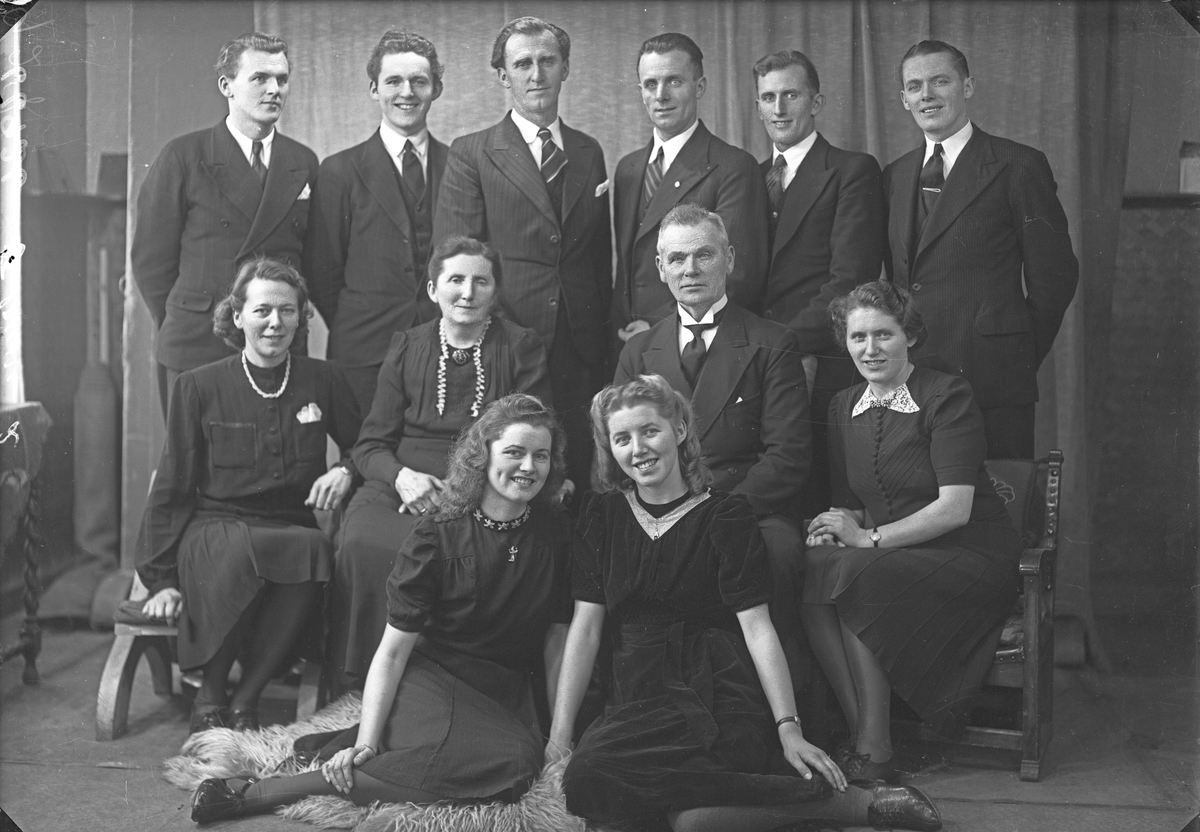 Gruppebilde. Familie. Gruppe på 12, en eldre mann, ei eldre kvinne, seks unge menn og fire unge kvinner.  Bestilt av Claus Dale. Skudenes.