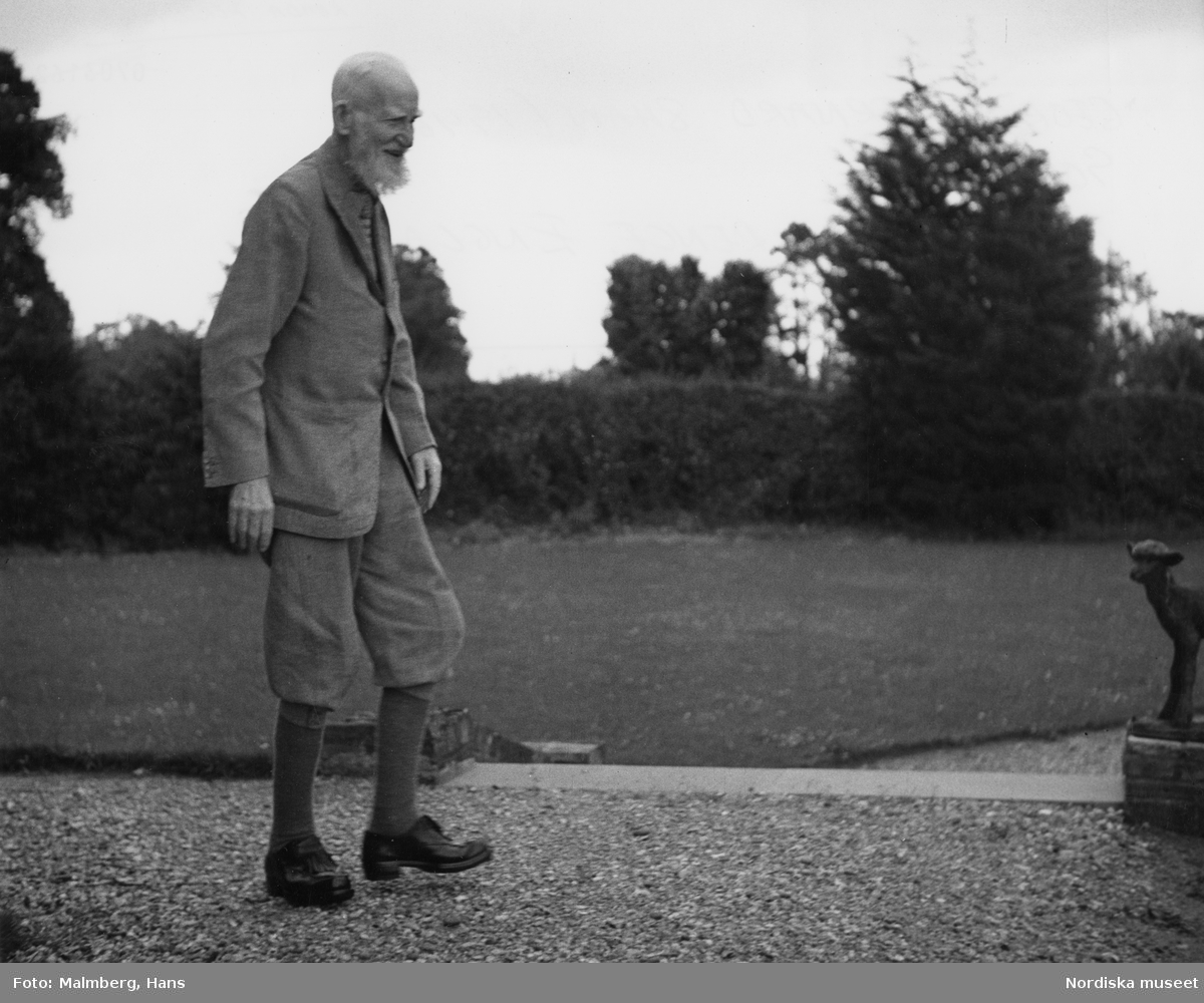 Porträtt utomhus i helfigur (profil) av den irländske 90-årige författaren George Bernhard Shaw. Nobelpristagare i litteratur 1925.