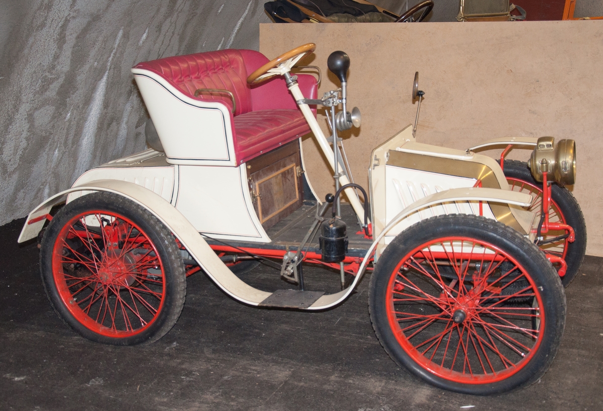 Tvåsitsig personbil. Fordonet var ursprungligen en Quadricycle av fabrikat De Dion årgång 1898. Karossen är påbyggd av tillverkaren Bailleau. Brittisk registreringsskylt AC494. JKF566 i bilregistret.
Tillbehör: Vev och diverse lösa delar(50st)