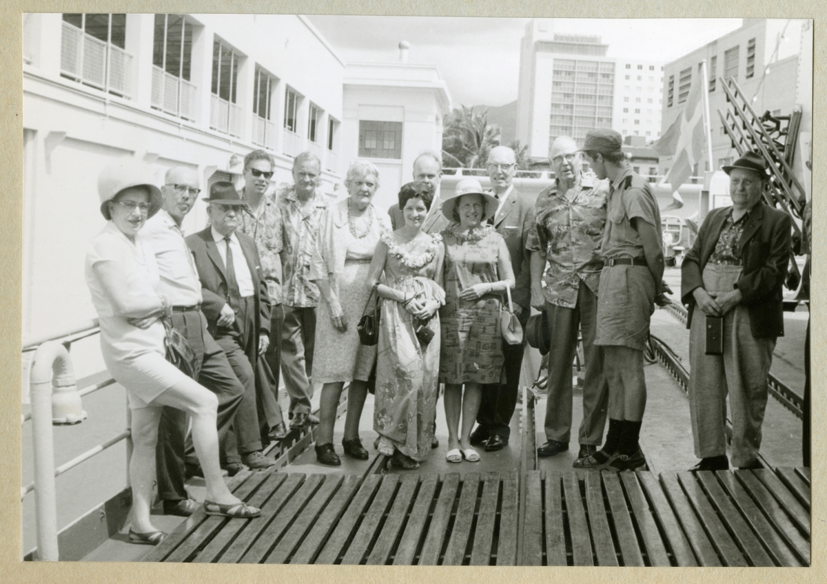 Bilden föreställer en grupp människor som poserar på minfartyget Älvsnabbens däck för att ta ett gruppfoto. Bilden är tagen under fartygets långresa 1966-1967.