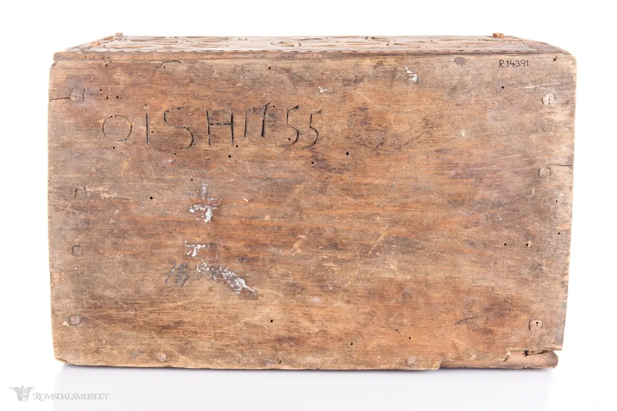 En stor og to små seksbladsroser i karveskurd på langsidene med skraverte dekorfelter og spetter rundt. På kortsidene er det skåret ut en stor seksbladsroser med rike dekorasjonsfelter bestående av spetter, streker diamantformer, sirkler med strek gjennom og solkors/kors. De største rosenen har kryss skåret inn på kronbladene.