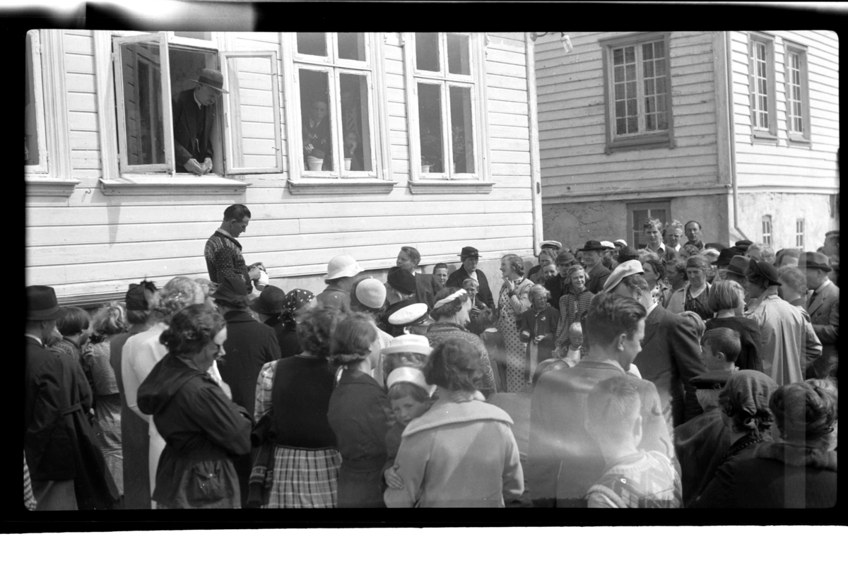 Mange mennesker er samlet under auksjonen over Katinka Tønnessens hus, auksjonarius Victor Wilhelmsen holder auksjonen. I bakgrunn står Rolf Sundt sr. og Sara Tønnessen, Loshavn. Fotografert 1939.