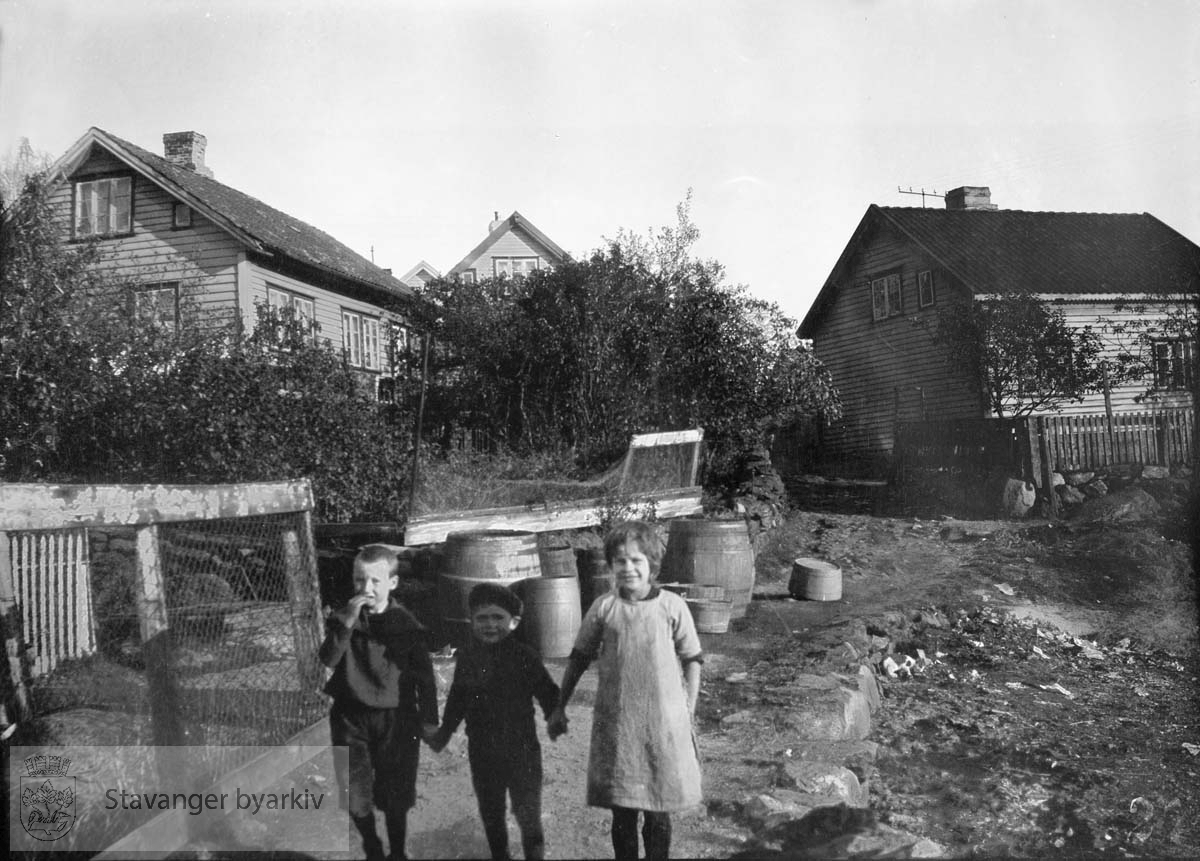 Tre barn foran hus på Buøy