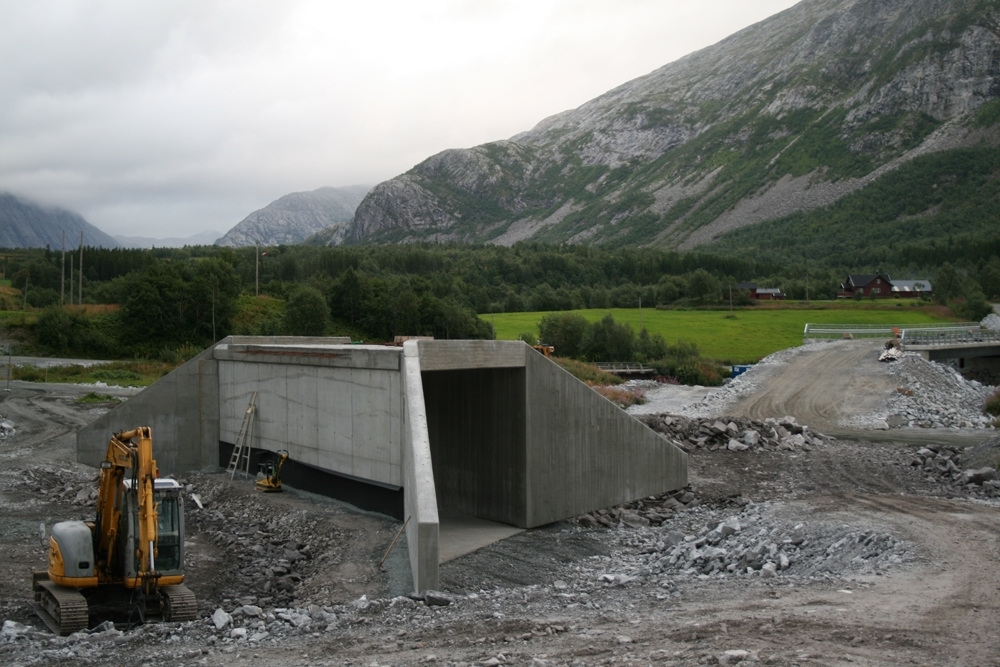 Leirfjord, Leira, Toventunnelen. Kulverten som er støpt til Vatnveien, sett fra oversiden. Gården Sommarsete midt i bilde til høyre.