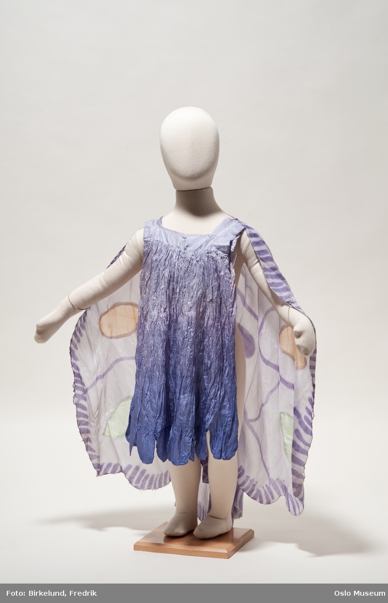 6 sommerfuglkostymer i barnestørrelse i ulikfarget silkestoff, brukt i ballettforestilling. Påmalt og applikert dekor. 1 ballettunderbukse.