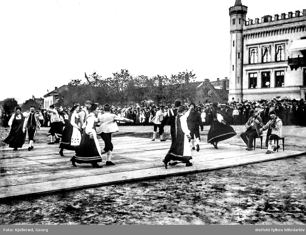 Akershus slott og festning. Festningsplassen og kommandantboligen.
17. mai 1905. Leikarring (BUL)  danser på en platting, spelemenn på fele.