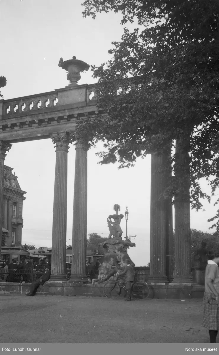 Motiv: Utlandet, Berlins Omgivningar 157 - 177 ;
En skulptur och en byggnad i bakgrunden, anteckningar på kontaktkarta 166 "Turistbåt på Wannsee" 167 "Arkad i Potsdam".