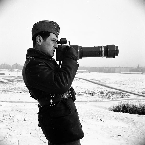 Sandstedt, Erik med kamera, långt objektiv.