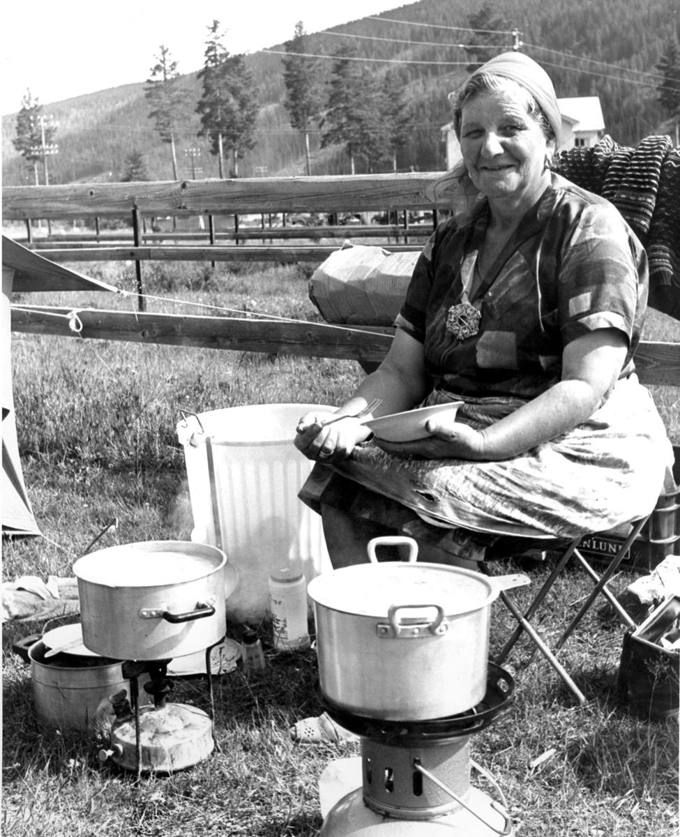 Traveling woman cooking on a meadow in Trysil, 1970