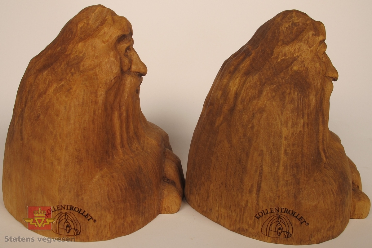 To skulpturer i treverk, som er utskåret i samme form og fasong som Kollentrollet. Trollene har innskriften KOLLENTROLLET® på siden og TYRI-STUBBEN STOMPERUD GÅRD HANDMADE IN NORWAY under.
