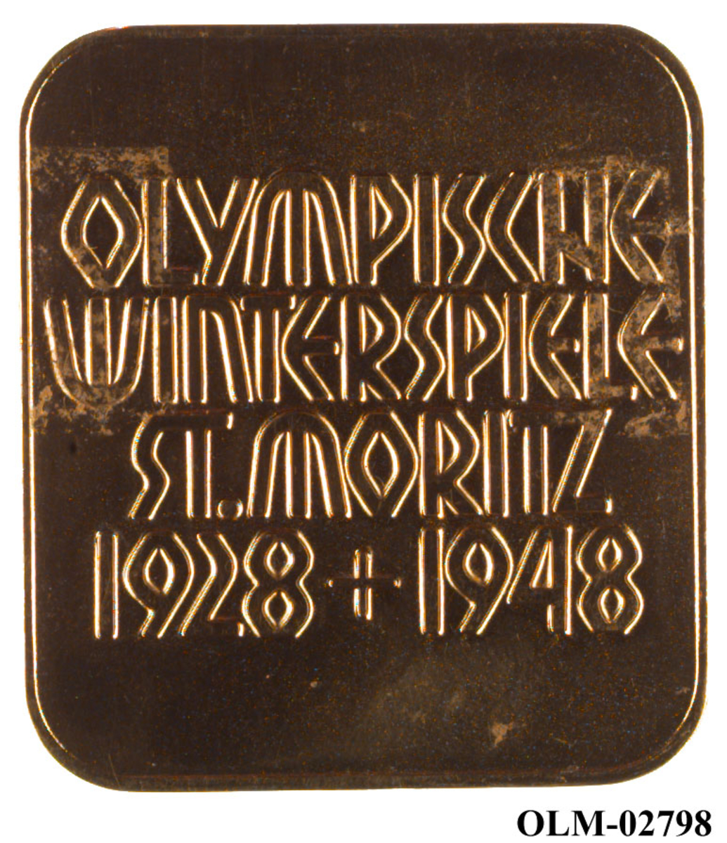 Gullfarget minnemedalje med motiv av en snøkrystall og de olympiske ringene.