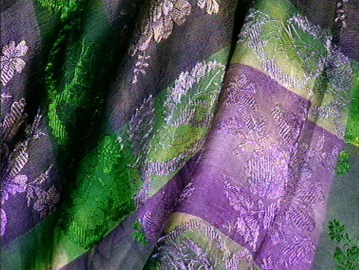 Silketørkle med brun midt og fiolette og grøne bårder, brosjert blomster.