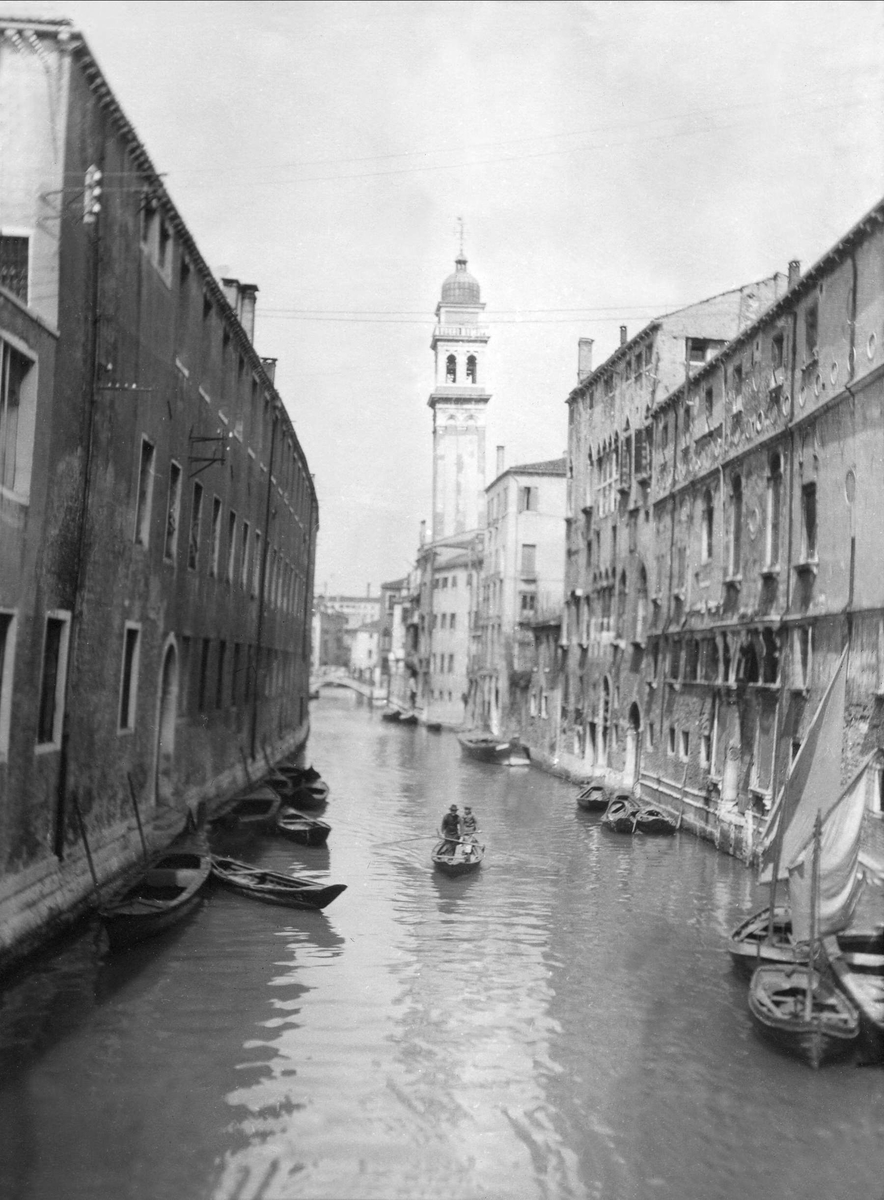 To mennesker i en båt på en kanal i Venezia.