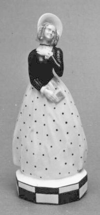 Figur i porslin föreställande en drömmande ung kvinna med ett
kärleksbrev i handen. Kvinnan är klädd i dräkt från 1700-talets mitt.