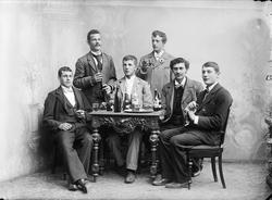 gruppe, menn6, stående og sittende helfigur, bord, brennevin