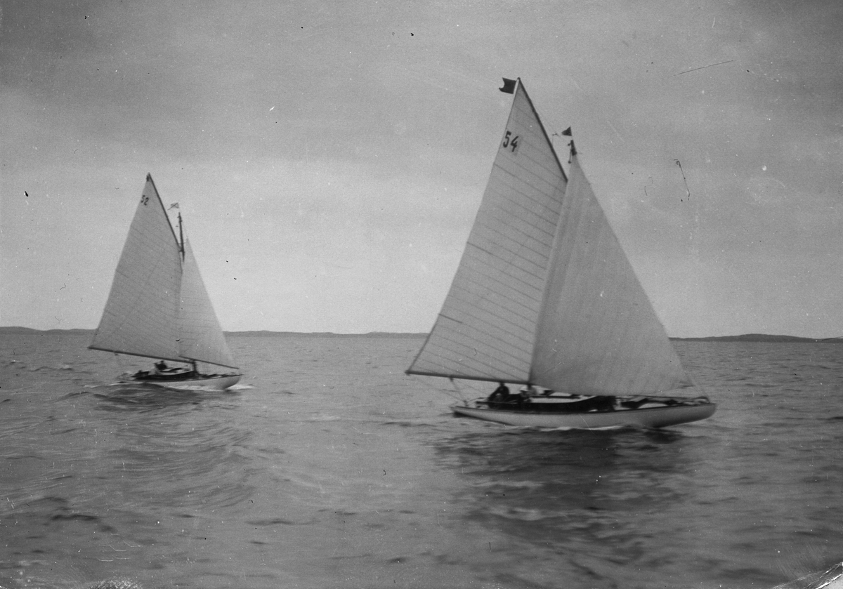 Från KSSS distanskappsegling i juli 1909 Furusund-Sandhamn-Nynäs. Bakom GERDA ses t v 55 m2 skärgårdskryssaren NORA (b. 1909, konstr. August Plym).