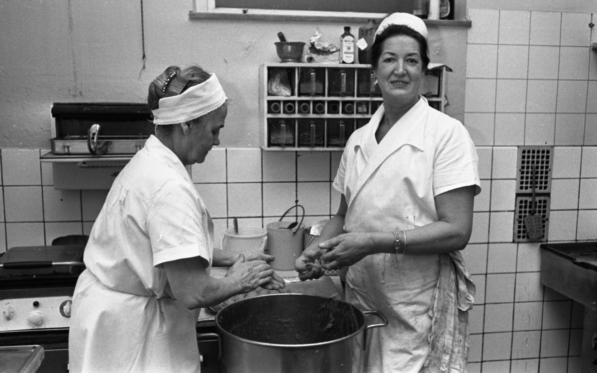 Fabriksmat, 9 mars 1966Två kokerskor klädda i vita arbetskläder är i färd med att rulla köttbullar.